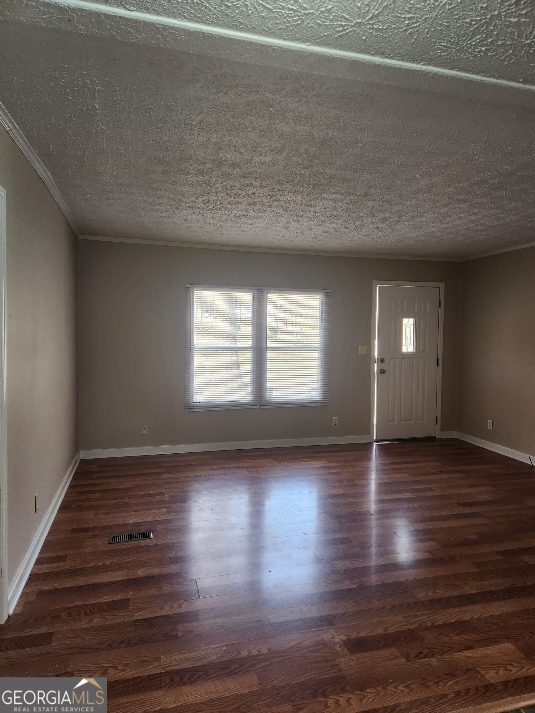 88 Dry Creek Road Danielsville, GA 30633 - Photo 7 of 20 a view of an empty room with wooden floor and a window