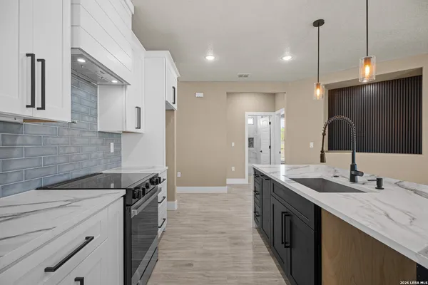 a kitchen with a sink stove and cabinets