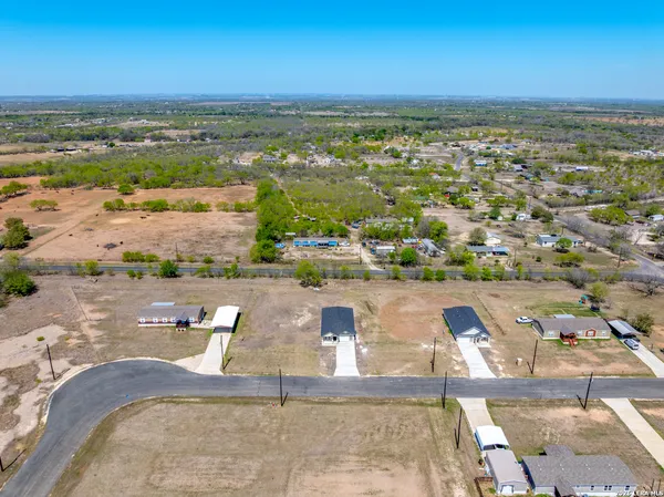 an aerial view of residential houses with outdoor space