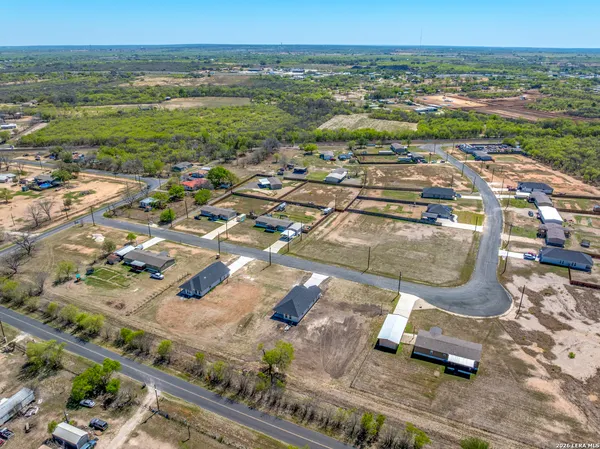 an aerial view of residential houses with outdoor space