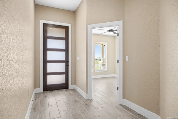 an empty room with closet and windows