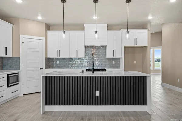 a kitchen with stainless steel appliances granite countertop a sink a stove and a refrigerator