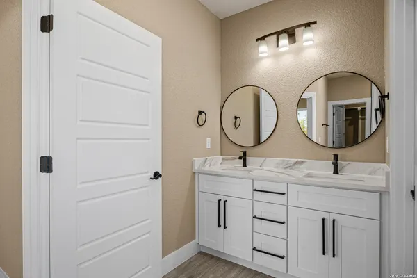 a bathroom with 2 sink and a mirror