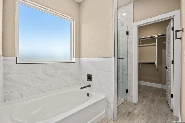 a bathroom with a bathtub and a shower