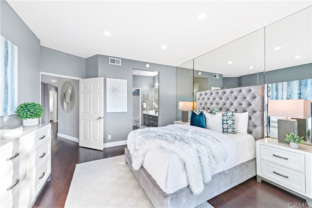 2 Vía Entrada Rancho Santa Margarita, CA 92688 - Photo 16 of 35 a spacious bedroom with a bed and a potted plant