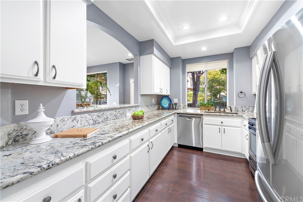 2 Vía Entrada Rancho Santa Margarita, CA 92688 - Photo 20 of 35 a kitchen with granite countertop a sink stainless steel appliances and window