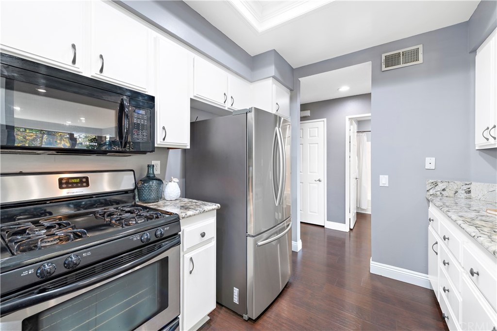 2 Vía Entrada Rancho Santa Margarita, CA 92688 - Photo 22 of 35 a kitchen with stainless steel appliances granite countertop a refrigerator stove and sink
