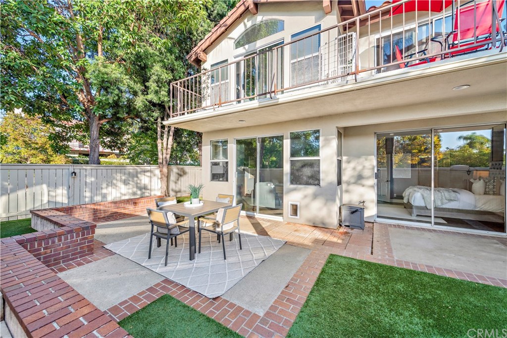 2 Vía Entrada Rancho Santa Margarita, CA 92688 - Photo 29 of 35 a view of a patio with table and chairs potted plants and floor to ceiling window