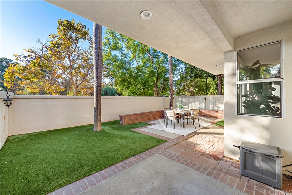 2 Vía Entrada Rancho Santa Margarita, CA 92688 - Photo 31 of 35 a view of a patio with table and chairs with wooden floor and fence