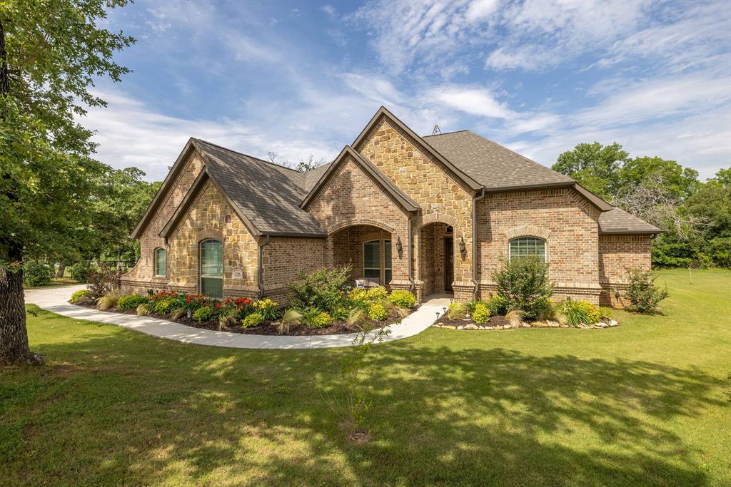 a front view of house with yard outdoor seating and green space