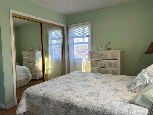 an empty room with wooden floor and a mirror