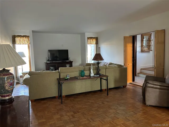 a view of a livingroom with furniture and a window