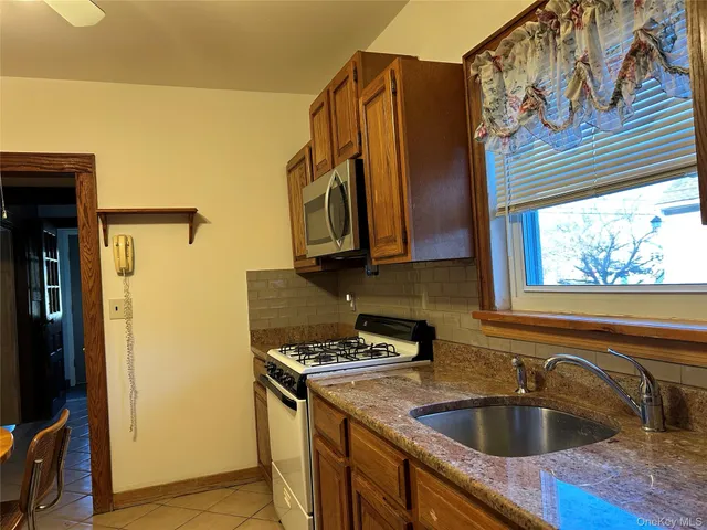 a bathroom with a shower and a sink mirror