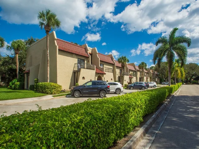 a view of a patio with table and chairs and potted plants