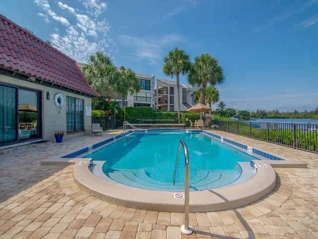 a swimming pool with outdoor seating and yard