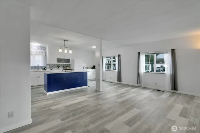a kitchen with stainless steel appliances kitchen island wooden cabinets and granite counter tops