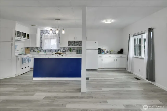 a view of kitchen with cabinets and window