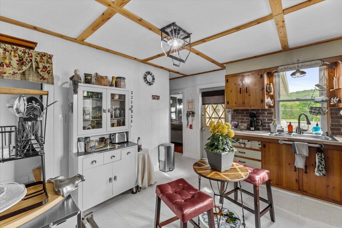 1937 Kunkletown Road Saylorsburg, PA 18353 - Photo 17 of 51 a kitchen with stainless steel appliances kitchen island granite countertop a table chairs in it and wooden floor