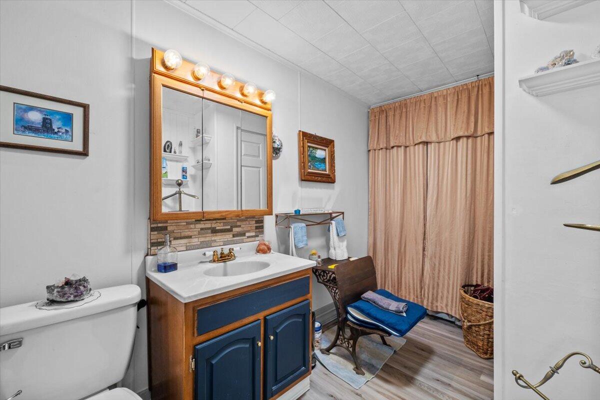 1937 Kunkletown Road Saylorsburg, PA 18353 - Photo 27 of 51 a bathroom with a sink a toilet a mirror and shower curtain