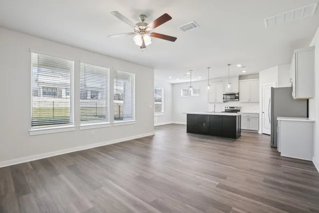 a view of kitchen with sink and wooden floor