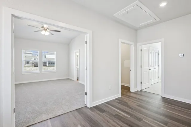 a view of an empty room with wooden floor