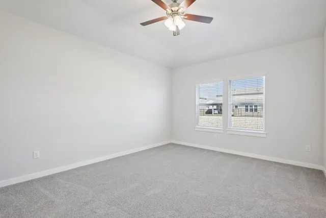 a view of empty room with a ceiling fan