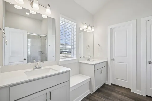 an empty room with closet and windows