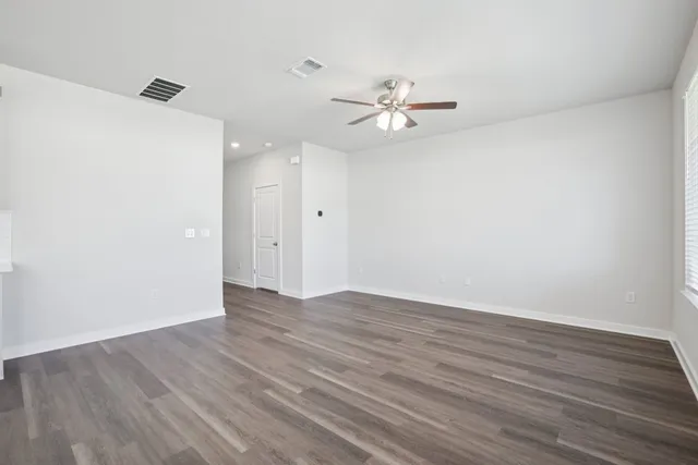 a view of kitchen with refrigerator microwave and wooden floor