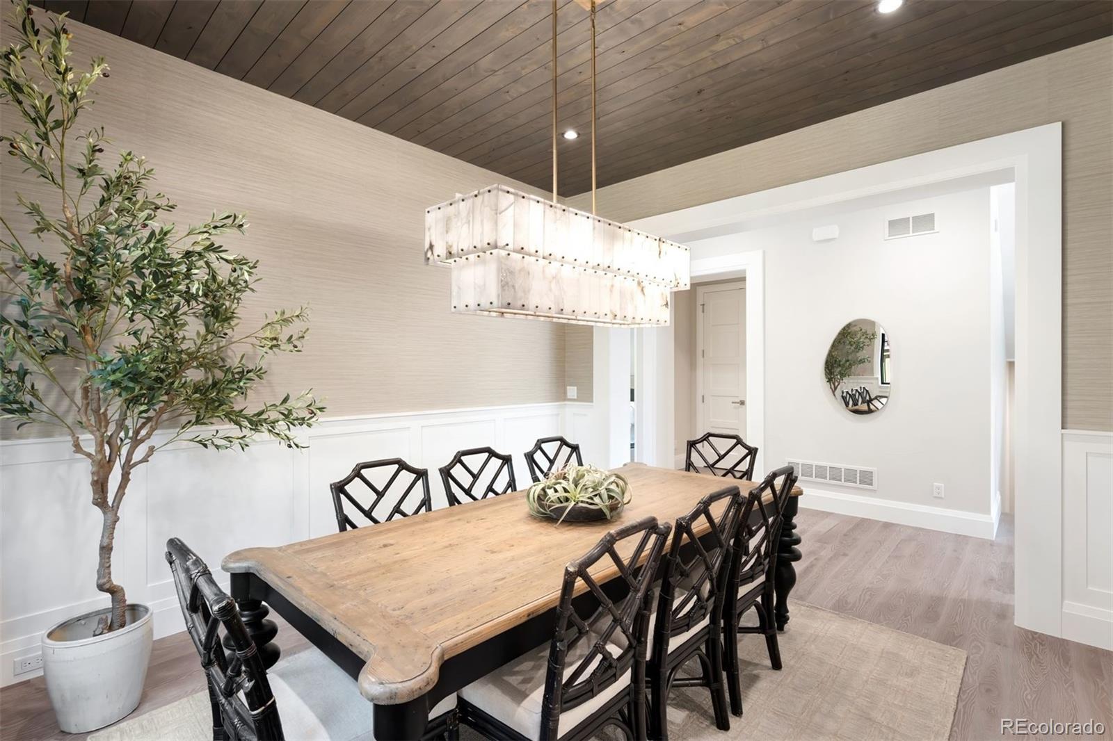 2237 South Madison Street Denver, CO 80210 - Photo 11 of 44 a view of a dining room with furniture and chandelier