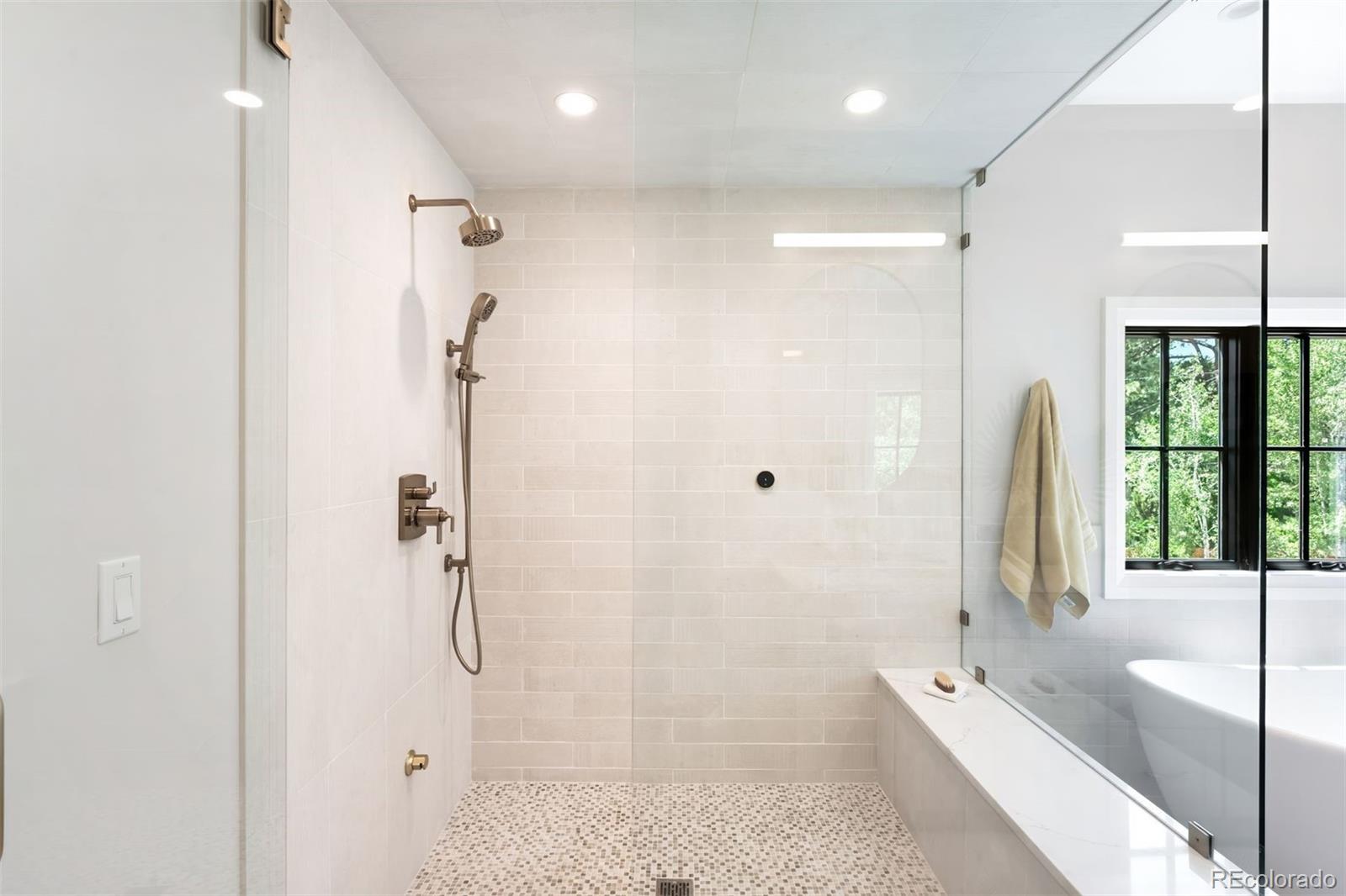 2237 South Madison Street Denver, CO 80210 - Photo 22 of 44 a bathroom with a tub shower and sink