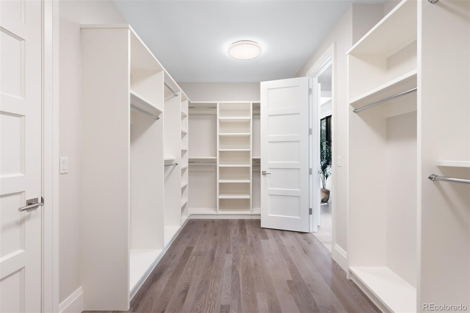 2237 South Madison Street Denver, CO 80210 - Photo 23 of 44 a view of walk in closet with wooden floor