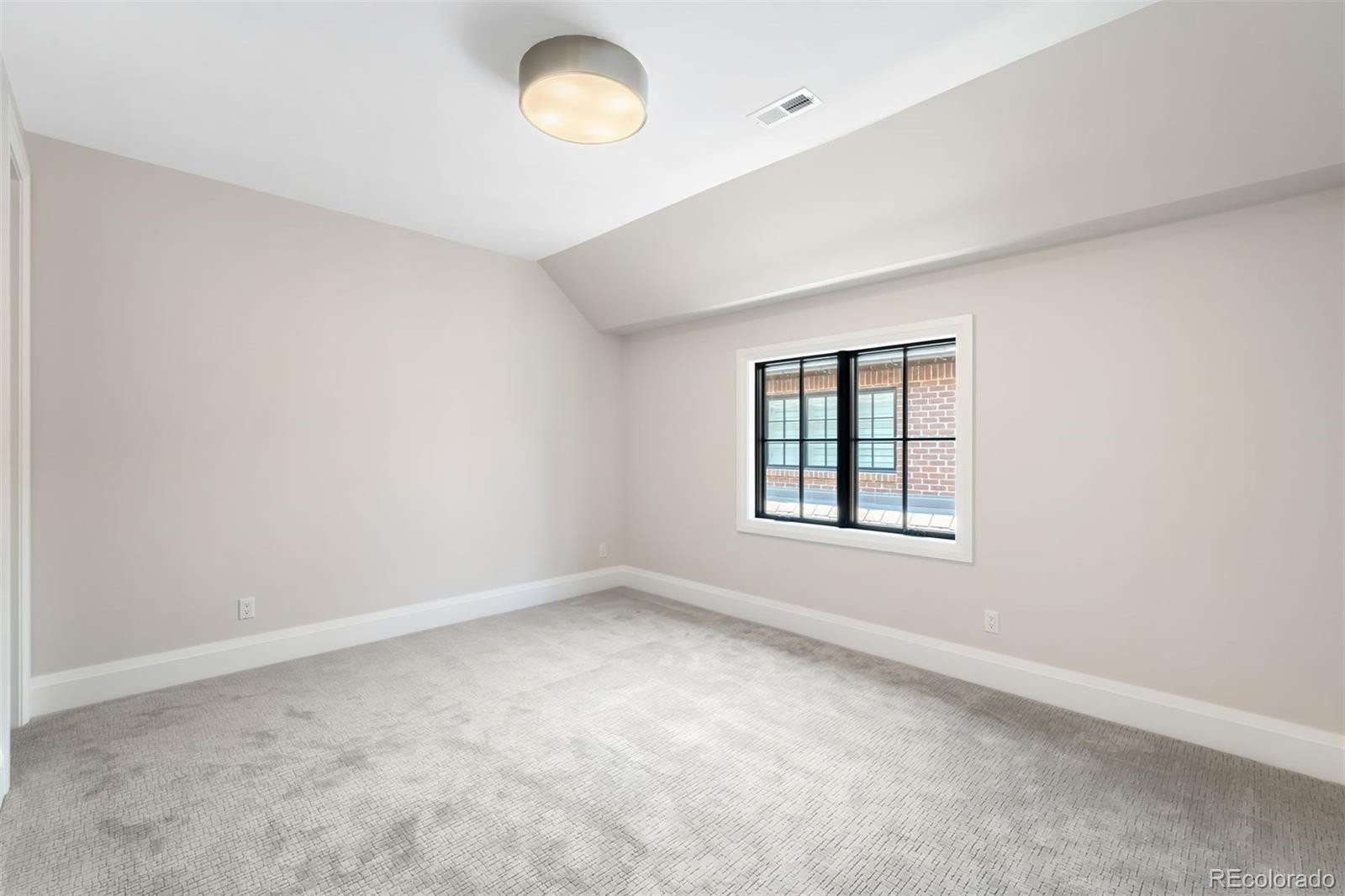 2237 South Madison Street Denver, CO 80210 - Photo 26 of 44 an empty room with a window