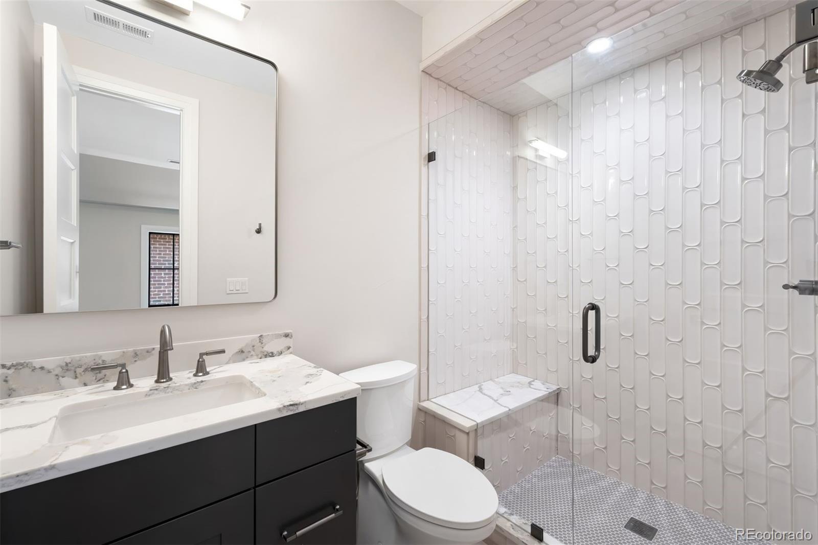 2237 South Madison Street Denver, CO 80210 - Photo 28 of 44 a bathroom with a sink a toilet and shower