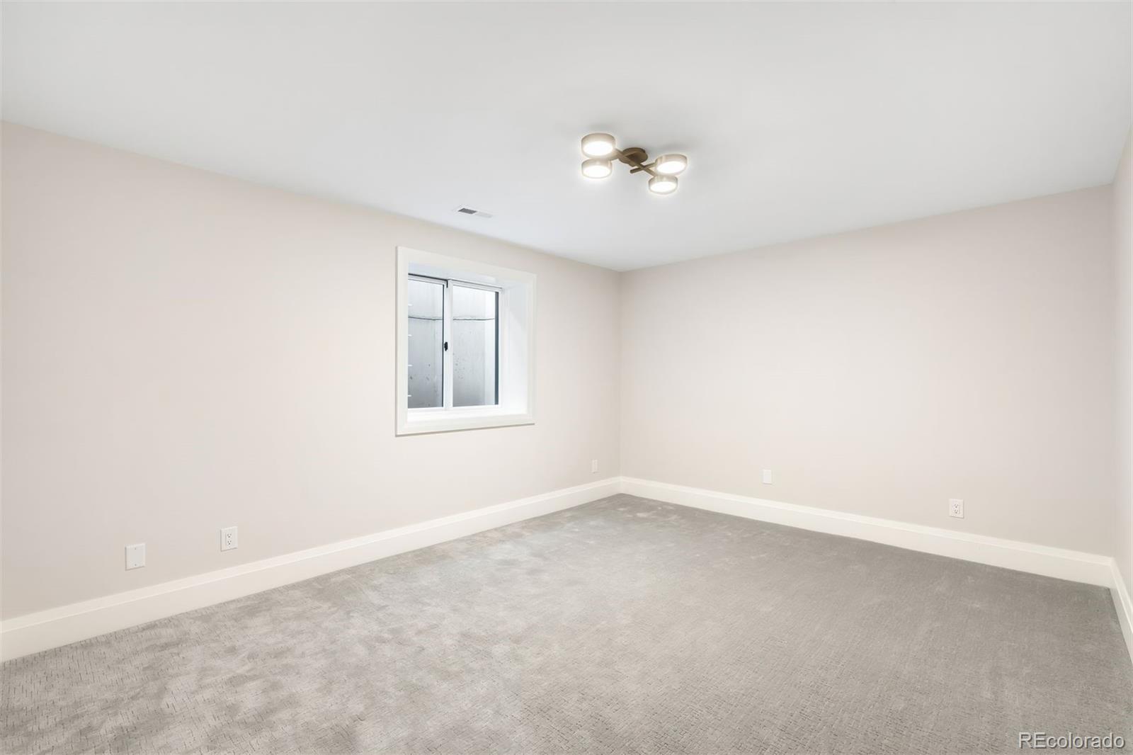 2237 South Madison Street Denver, CO 80210 - Photo 39 of 44 an empty room with a window