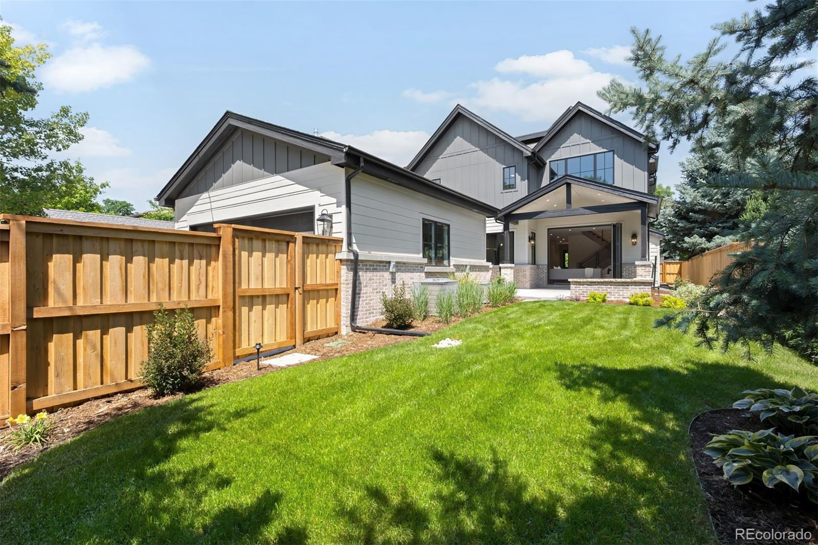 2237 South Madison Street Denver, CO 80210 - Photo 43 of 44 a front view of a house with a yard and porch