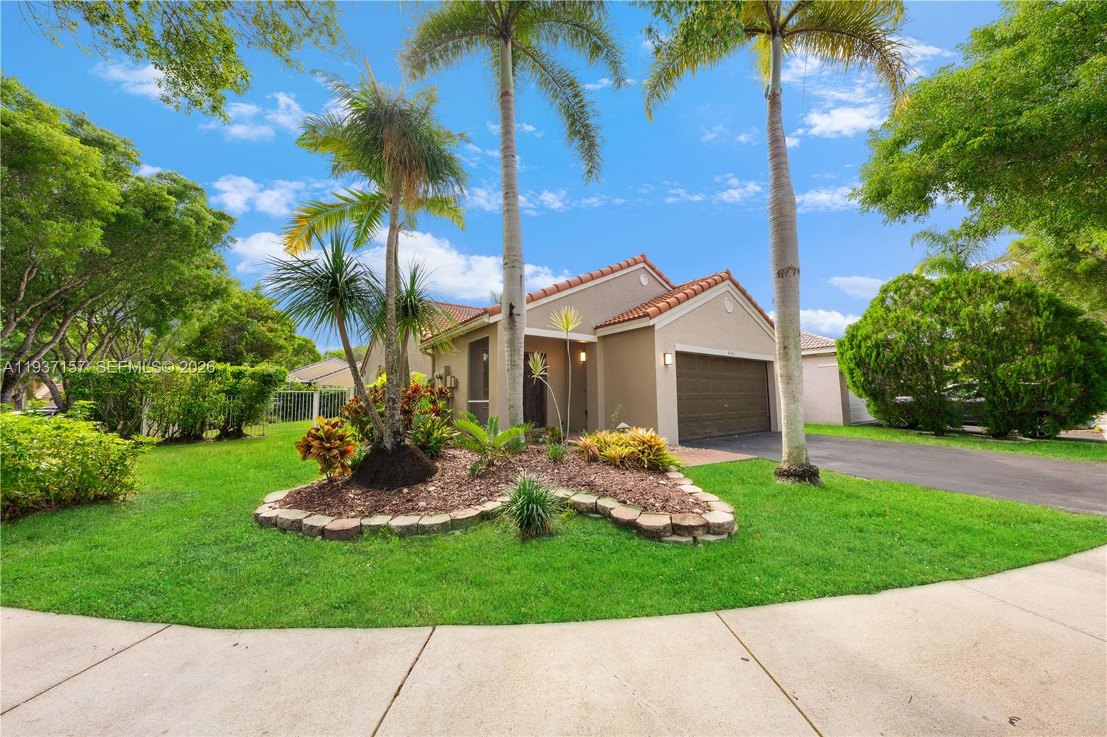 4361 Mahogany Ridge Drive Weston, FL 33331 - Photo 11 of 47 a front view of a house with a yard and garage