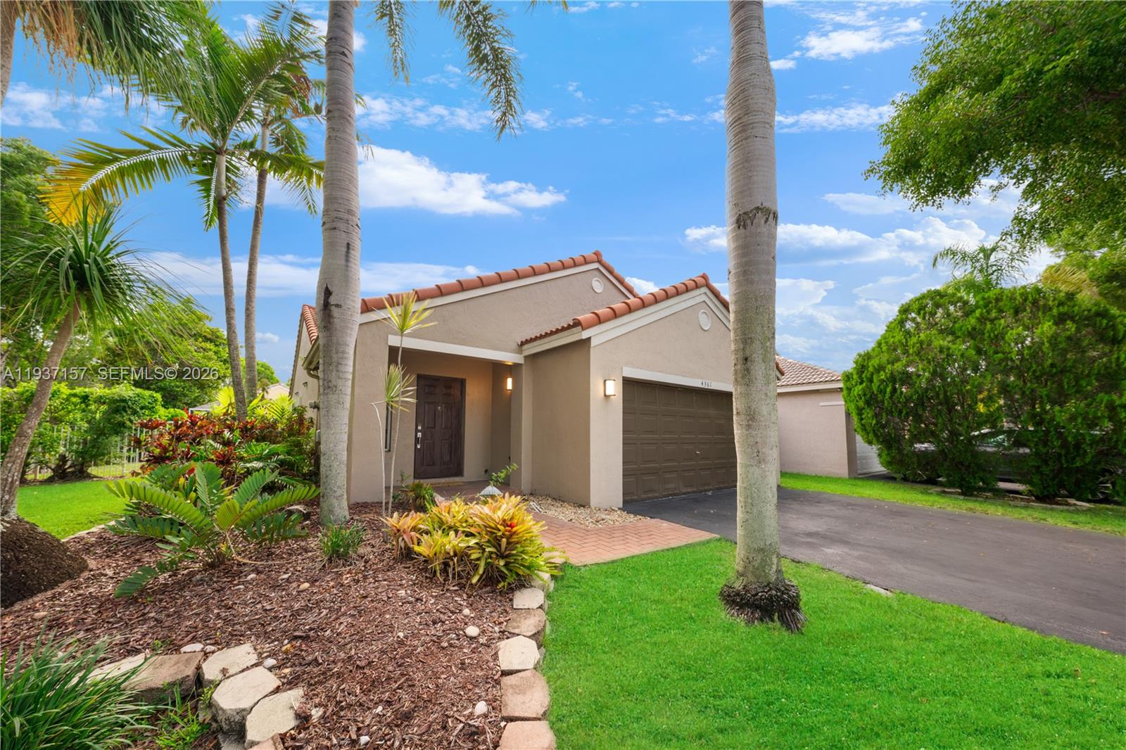 4361 Mahogany Ridge Drive Weston, FL 33331 - Photo 14 of 47 a front view of a house with garden