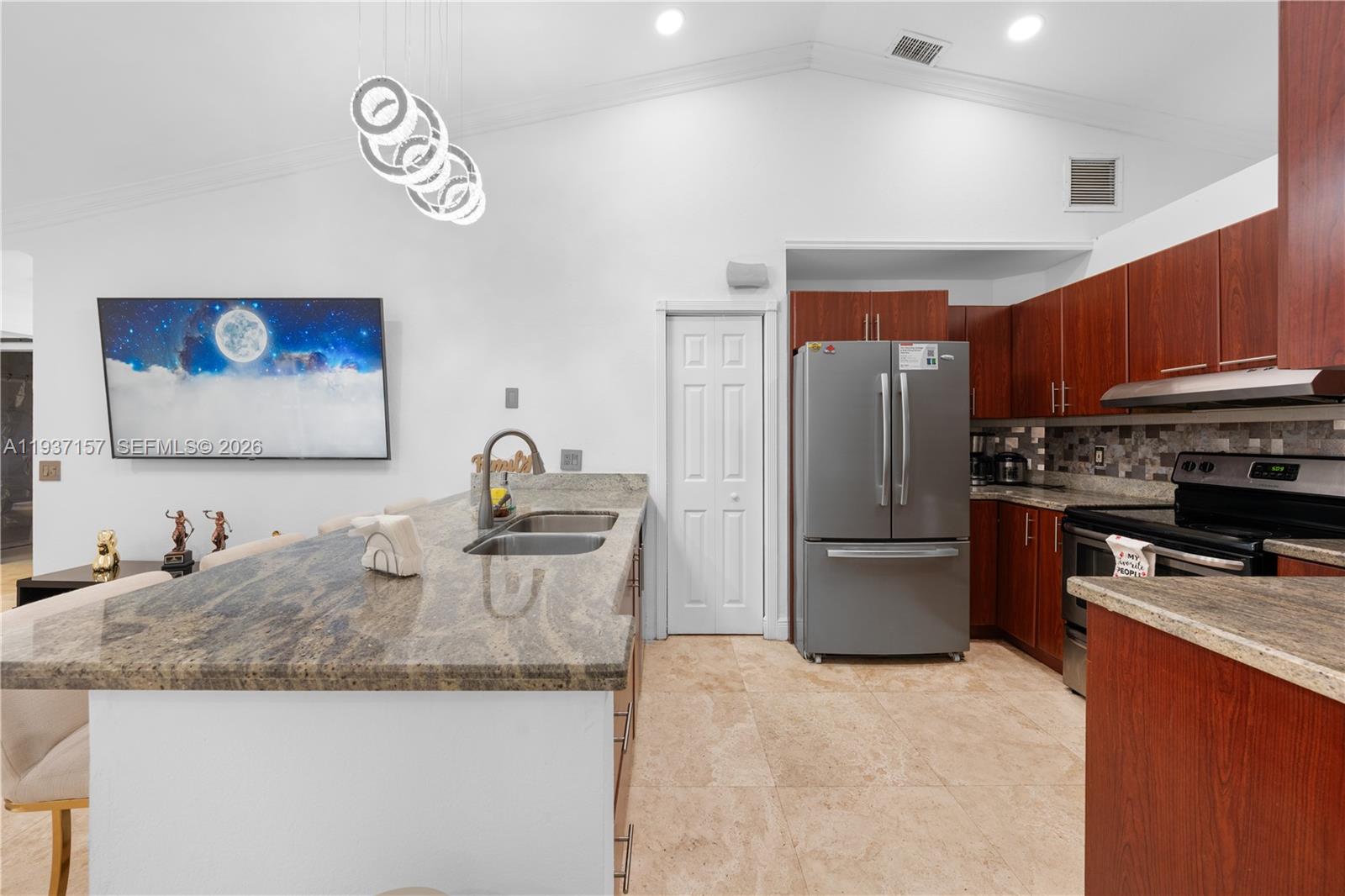 4361 Mahogany Ridge Drive Weston, FL 33331 - Photo 26 of 47 a kitchen with a refrigerator sink and a stove top oven