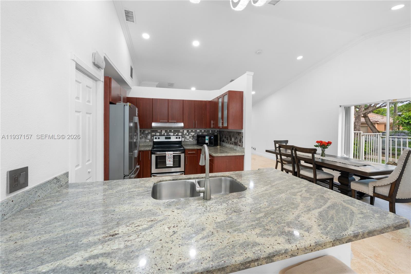 4361 Mahogany Ridge Drive Weston, FL 33331 - Photo 30 of 47 a kitchen with stainless steel appliances kitchen island granite countertop a sink and a stove
