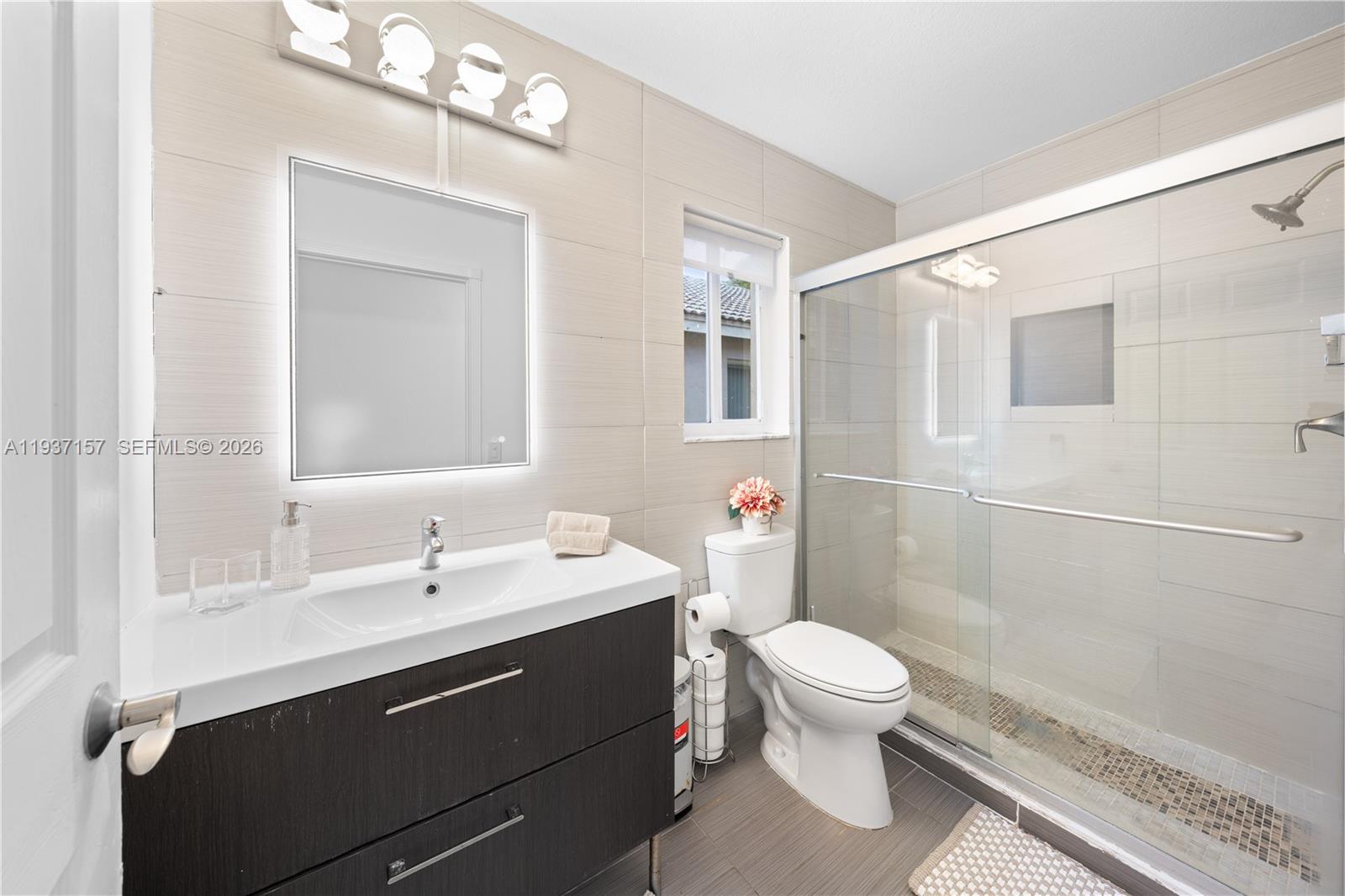4361 Mahogany Ridge Drive Weston, FL 33331 - Photo 41 of 47 a bathroom with a sink a toilet a mirror and shower
