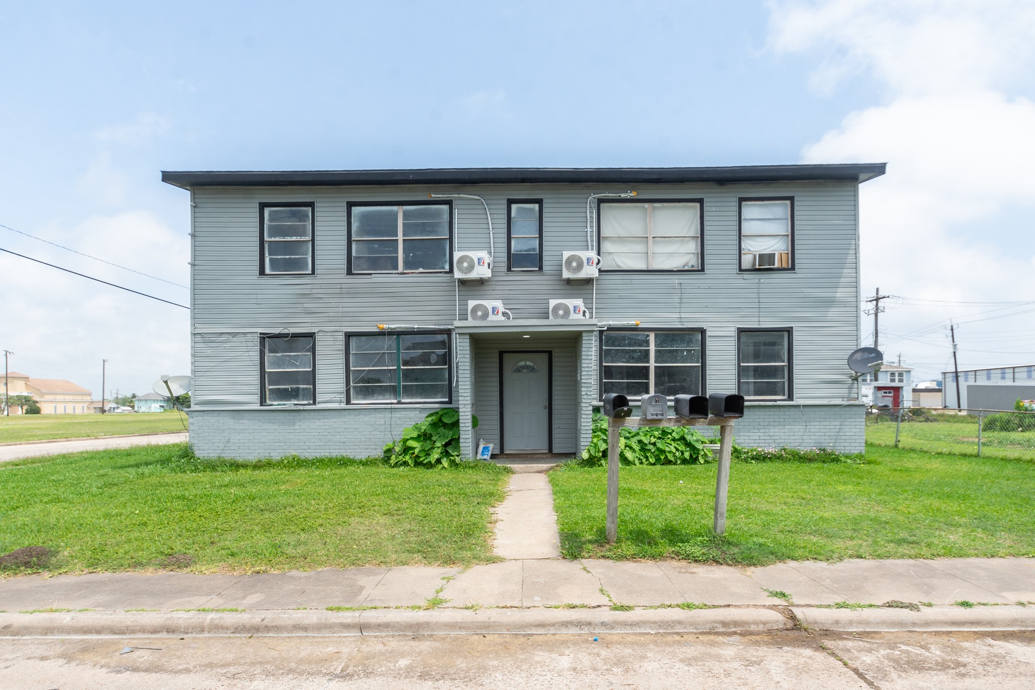 a front view of house with yard and green space