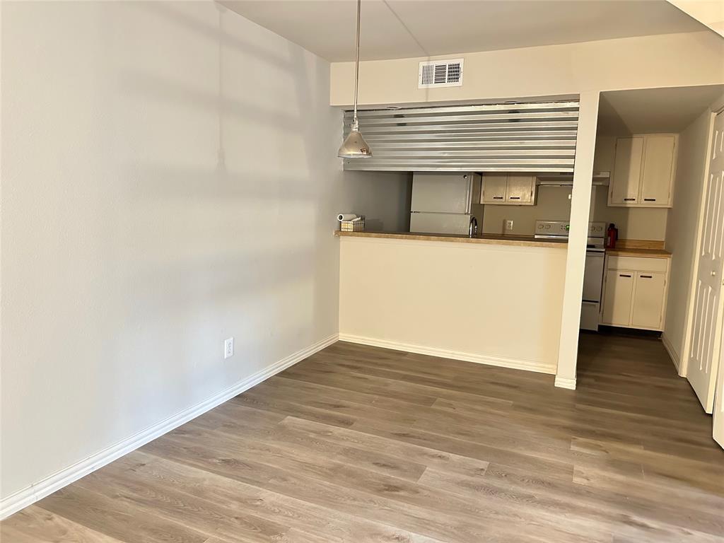 Undisclosed Address Dallas, TX 75220 - Photo 7 of 22 a view of an empty room with wooden floor