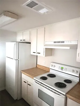 a kitchen with a stove and a refrigerator