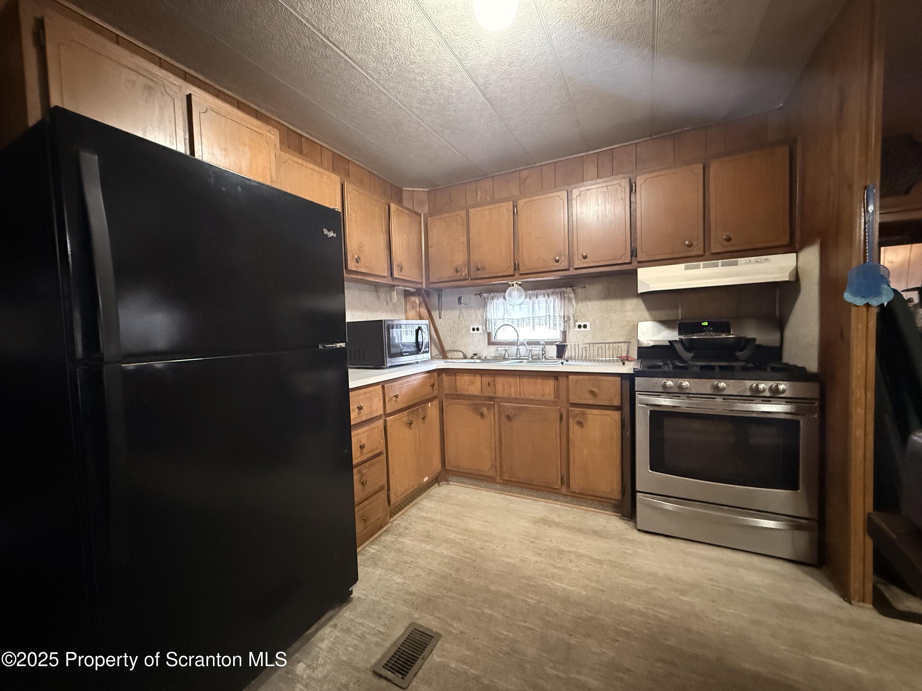130 Fisk Mill Road Montrose, PA 18801 - Photo 11 of 31 a kitchen with a refrigerator stove and a sink