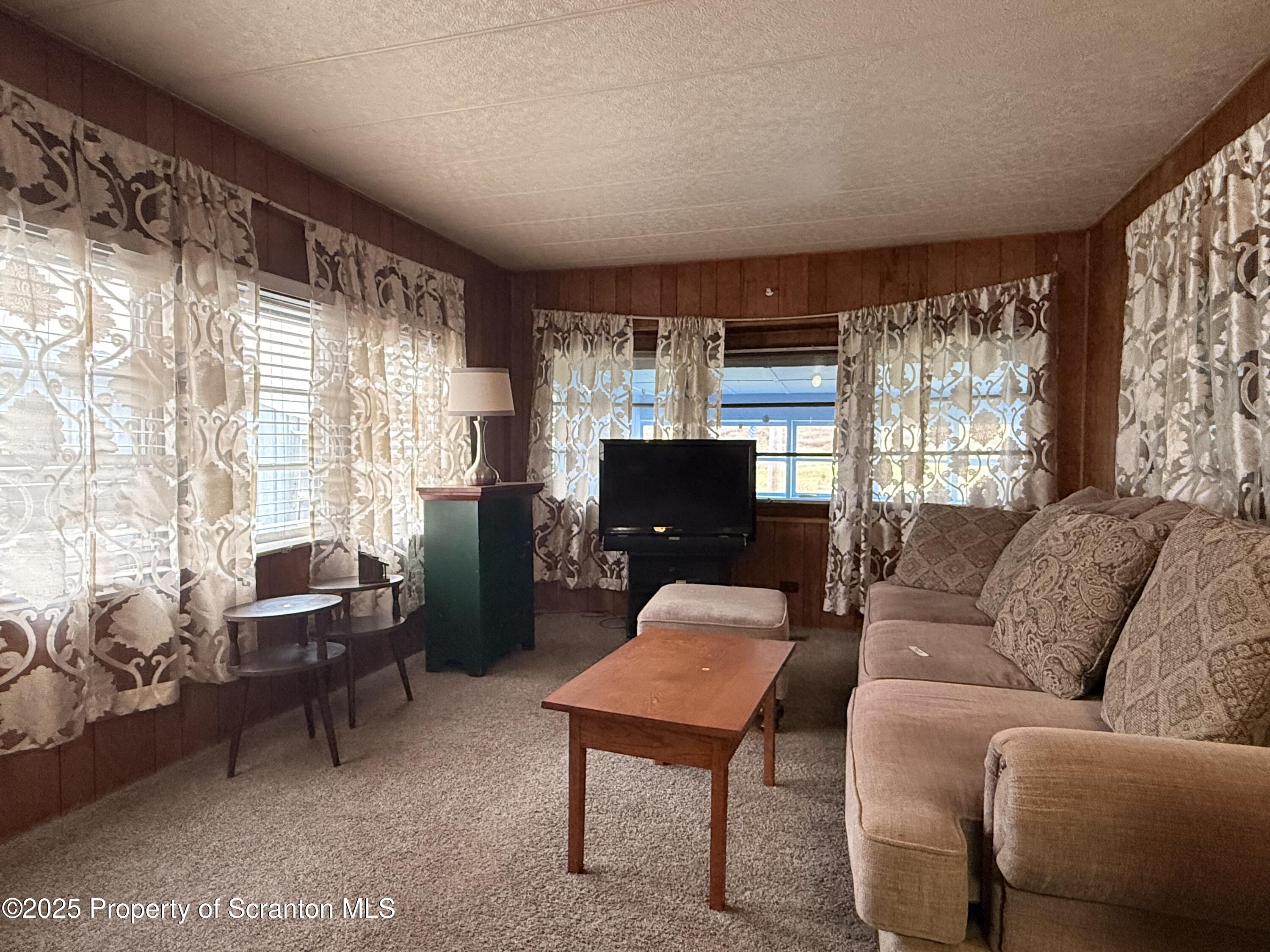 130 Fisk Mill Road Montrose, PA 18801 - Photo 12 of 31 a living room with furniture and a flat screen tv