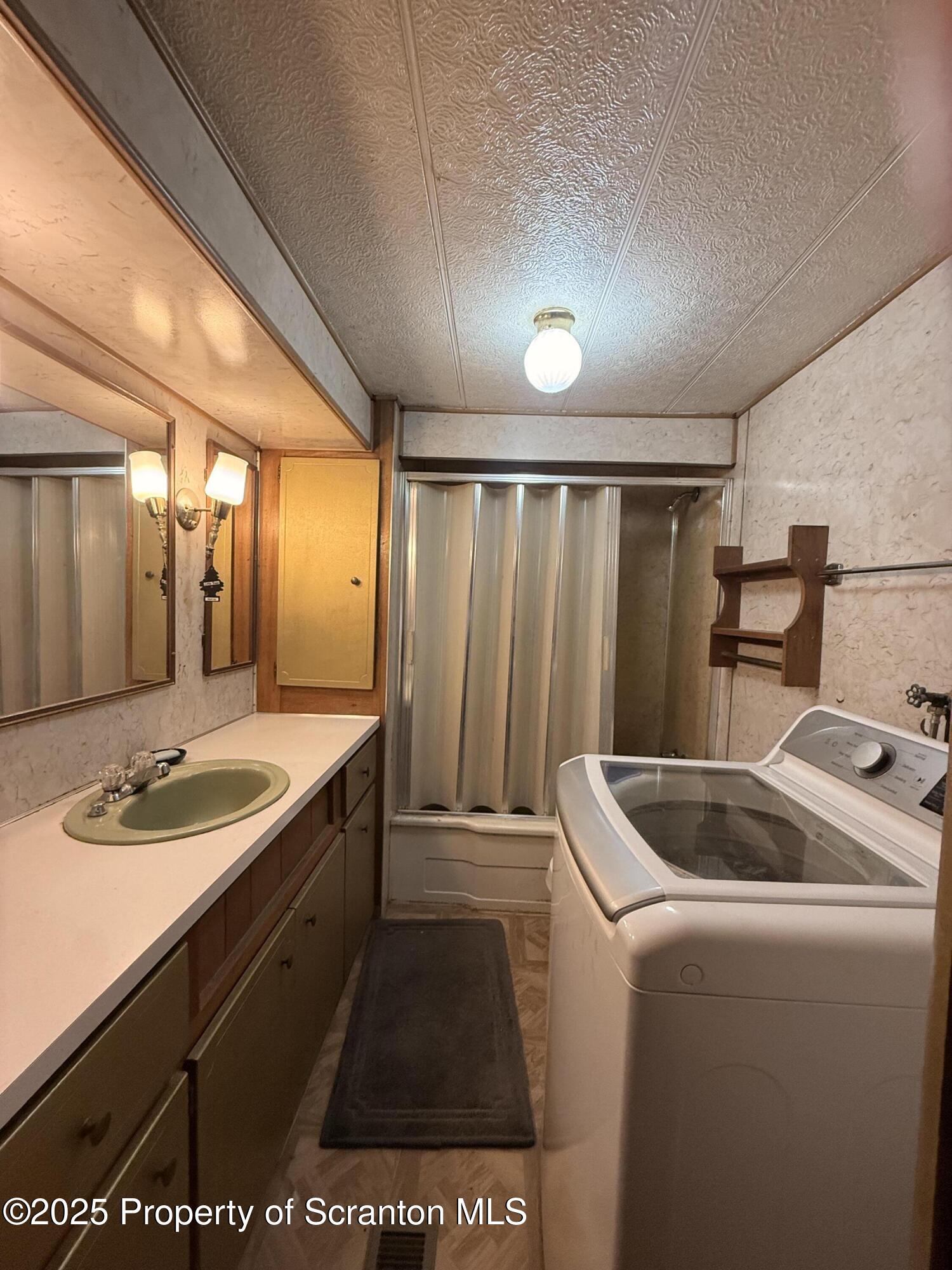 130 Fisk Mill Road Montrose, PA 18801 - Photo 15 of 31 a bathroom with a sink and a large mirror