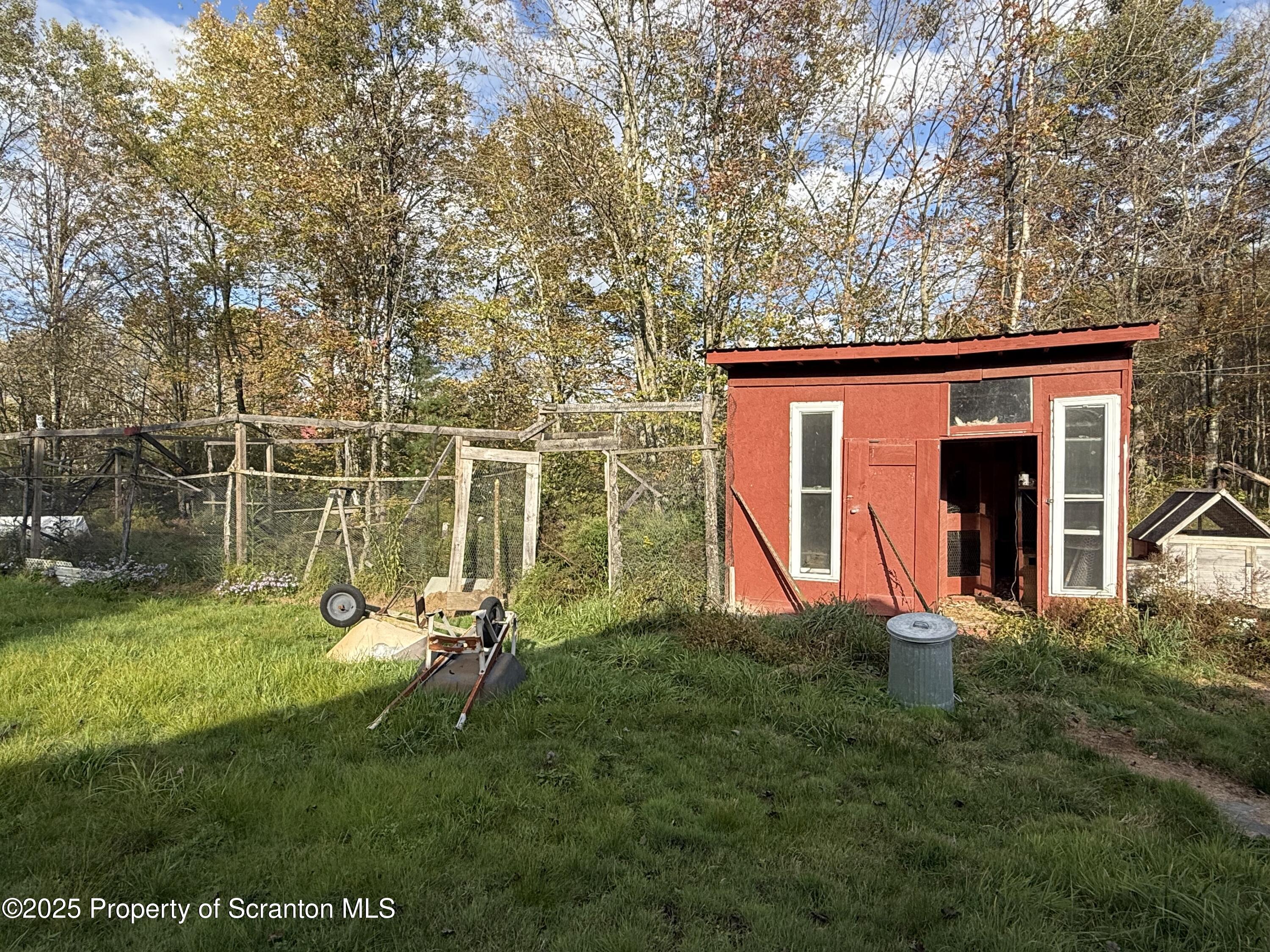 130 Fisk Mill Road Montrose, PA 18801 - Photo 21 of 31 a view of a backyard with table and chairs and wooden fence