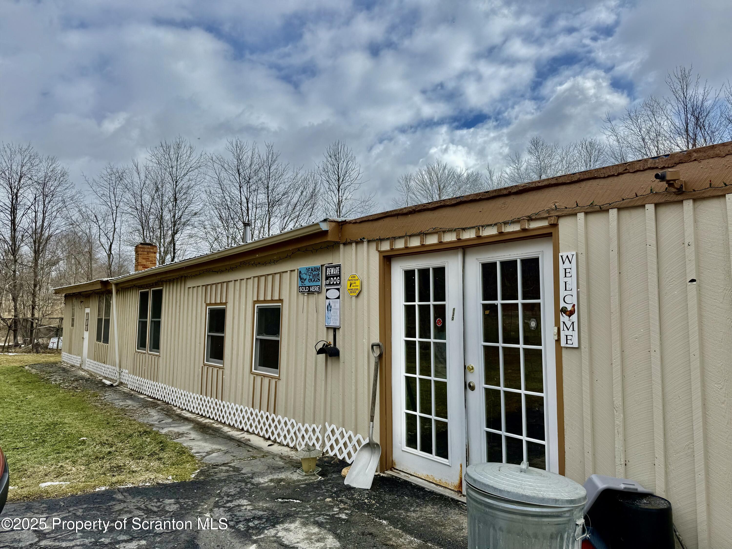 130 Fisk Mill Road Montrose, PA 18801 - Photo 3 of 31 a view of a house with a large window and wooden fence