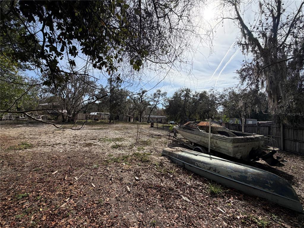 10711 Jacamar Drive New Port Richey, FL 34654 - Photo 13 of 19 a backyard of a house with lots of green space