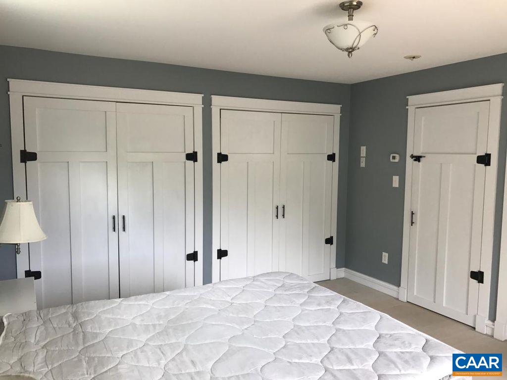 8497 Laurel Road Shipman, VA 22971 - Photo 17 of 37 a view of a bedroom with a chandelier and closet area